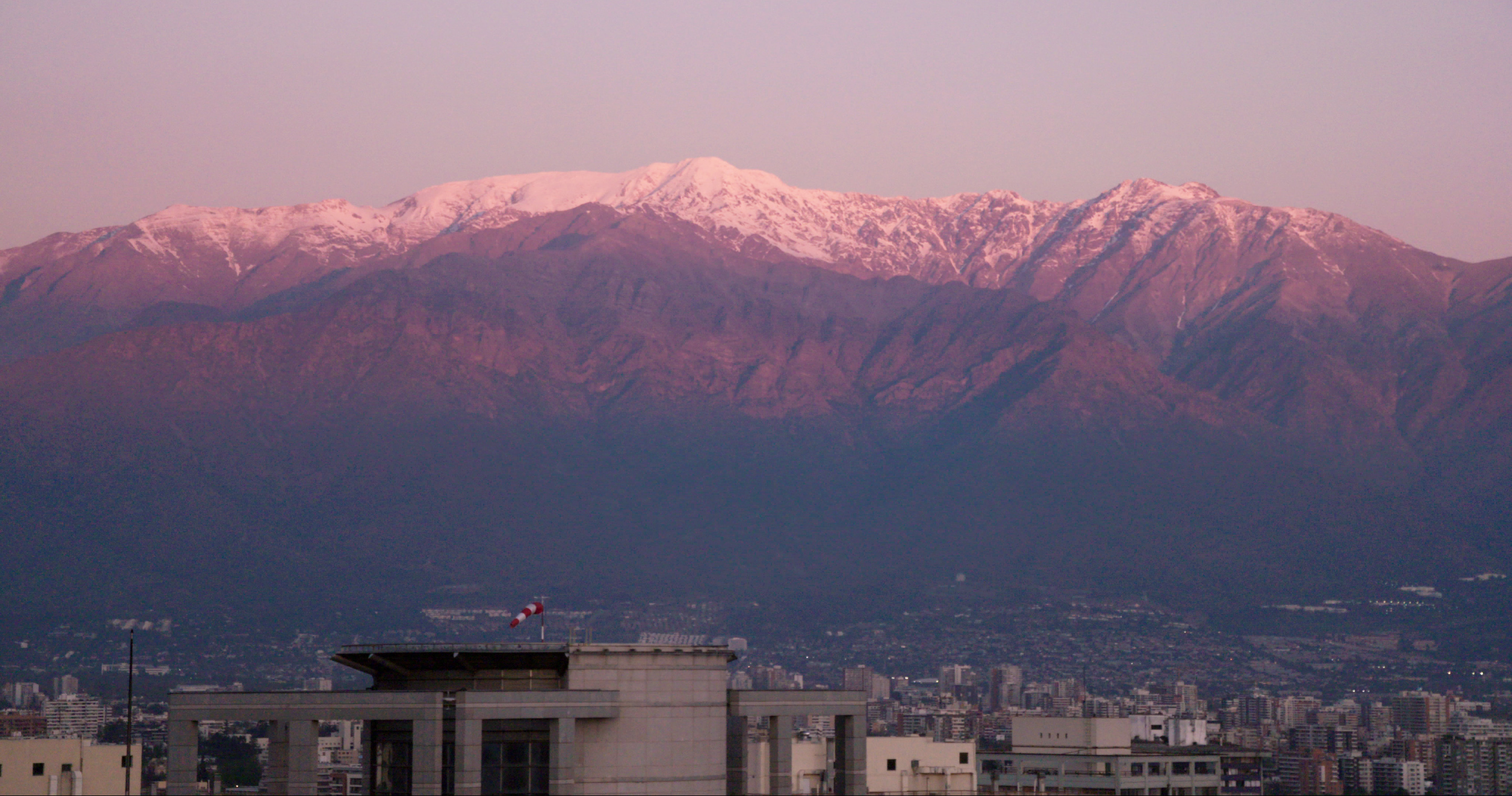 THE CORDILLERA OF DREAMS (still image of a snow-topped mountain range behind the buildings of a city)