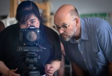 Jim Haverkamp, right, helps Mara Guevarra, digital marketing and projects manager for Duke's Center for Documentary Studies.