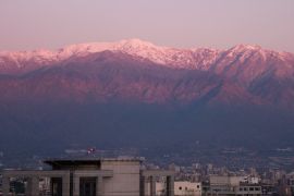 THE CORDILLERA OF DREAMS (still image of a snow-topped mountain range behind the buildings of a city)