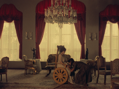Film still depicted to young women in a lavishly room with an impressive chandelier, from "Chess of the Wind"