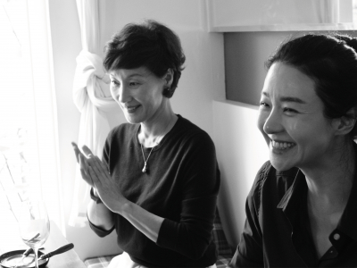 Two women seated at a kitchen table in a still from Hong Sang-soo's Walk Up.