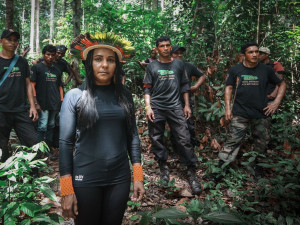 A group of indigenous activists stand in the Amazon rainforest in a still image from We Are Guardians.